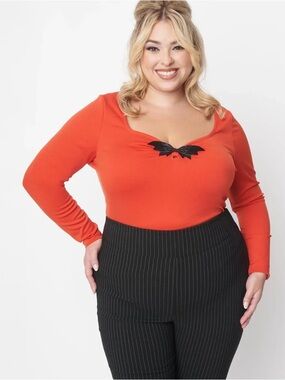 Unique Vintage Orange Long Sleeve Scoop Neck Top with Black Bow Accent